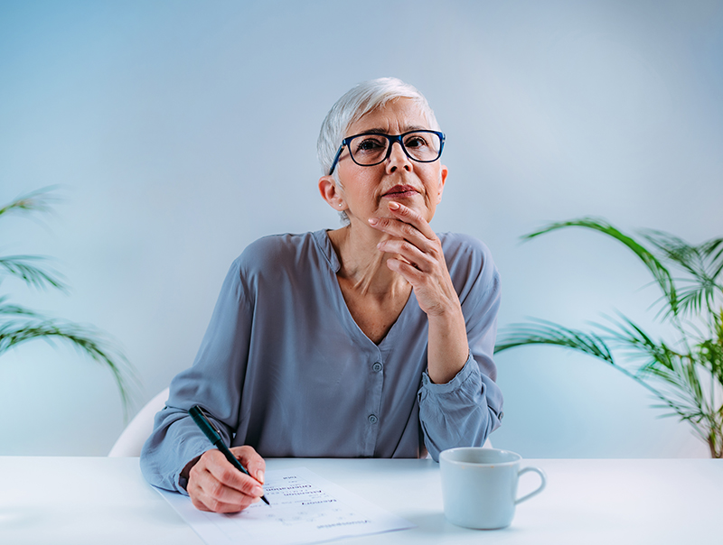 older woman taking a test looking thoughtful but calm