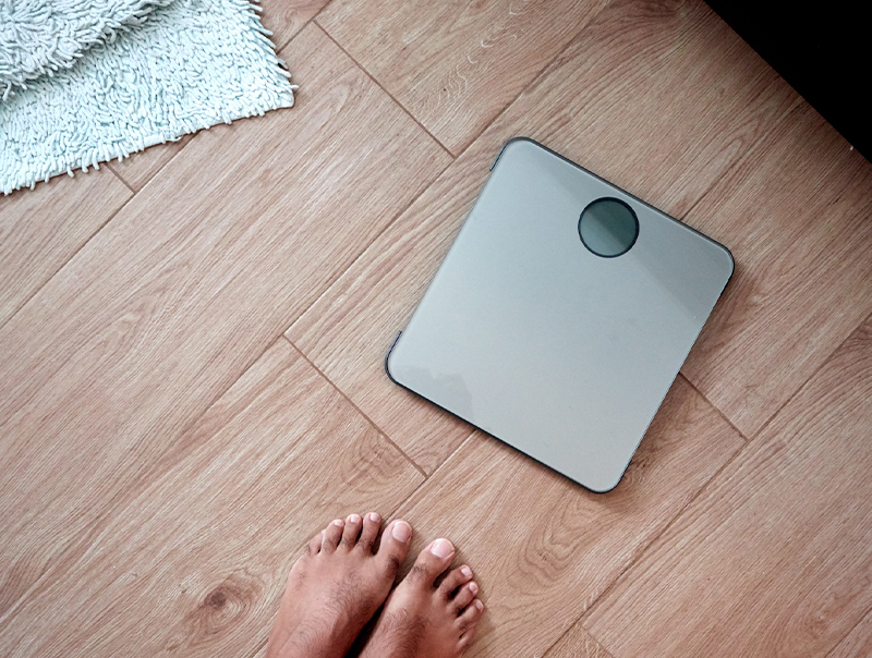 bathroom scale seen in first person man about to weigh himself