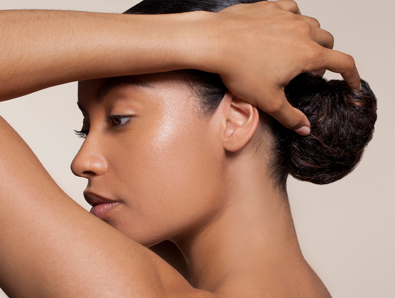 Young healthy woman touching her hair bun